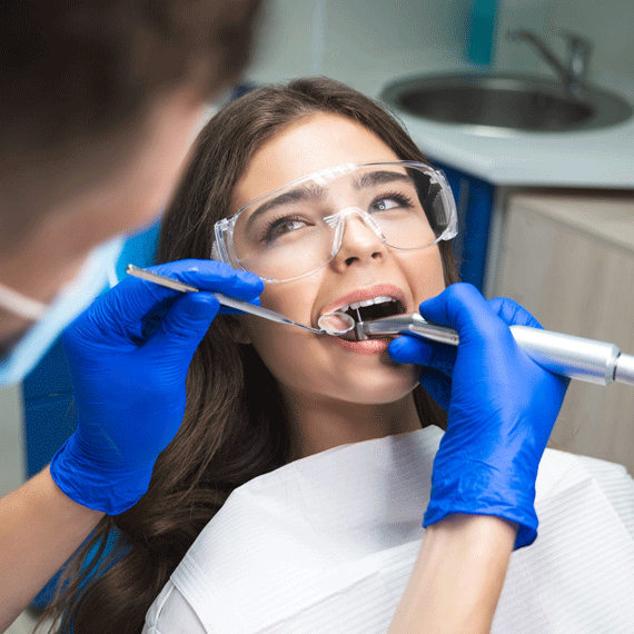 A woman sitting in a dentist's chair.